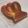 A chocolate heart sitting on top of a clear stand.