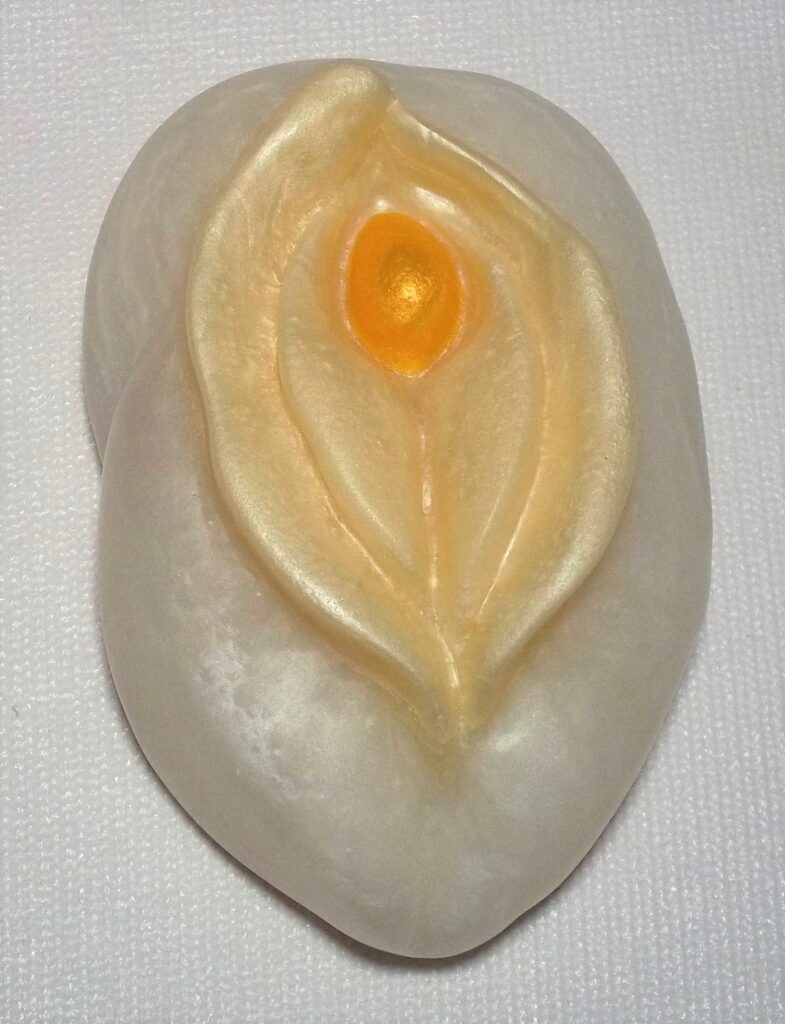 White soap carved with abstract floral design.