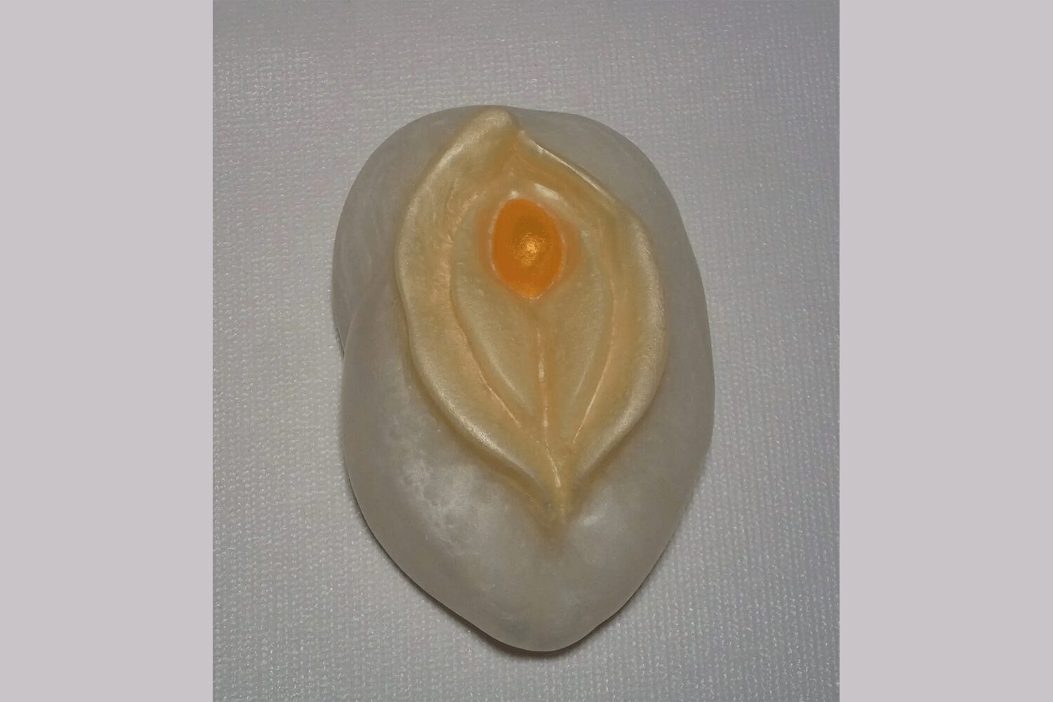 A white object with an orange center on top of it.