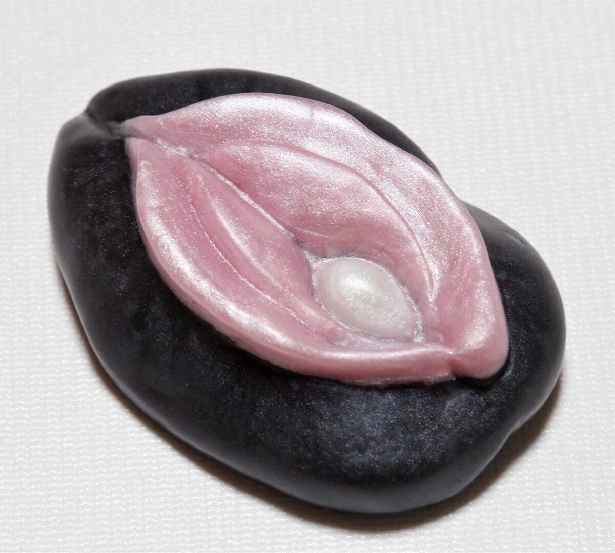 Black stone with pink leaf design.