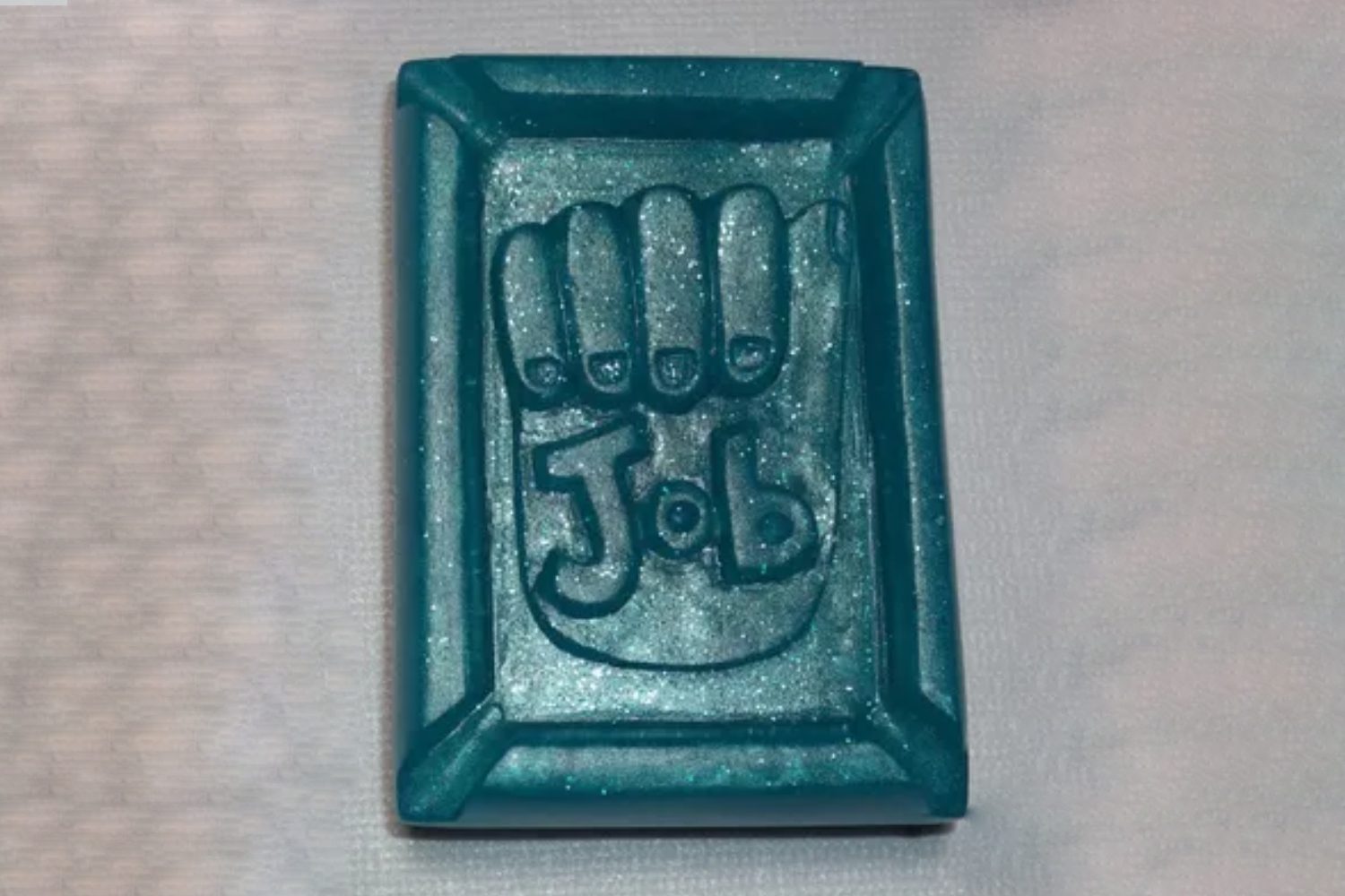 A blue rectangular object with the word " job " written in it.