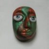 A green and red face with blue eyes.