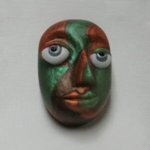 A green and red face with blue eyes.