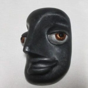 A black face with brown eyes and a nose.