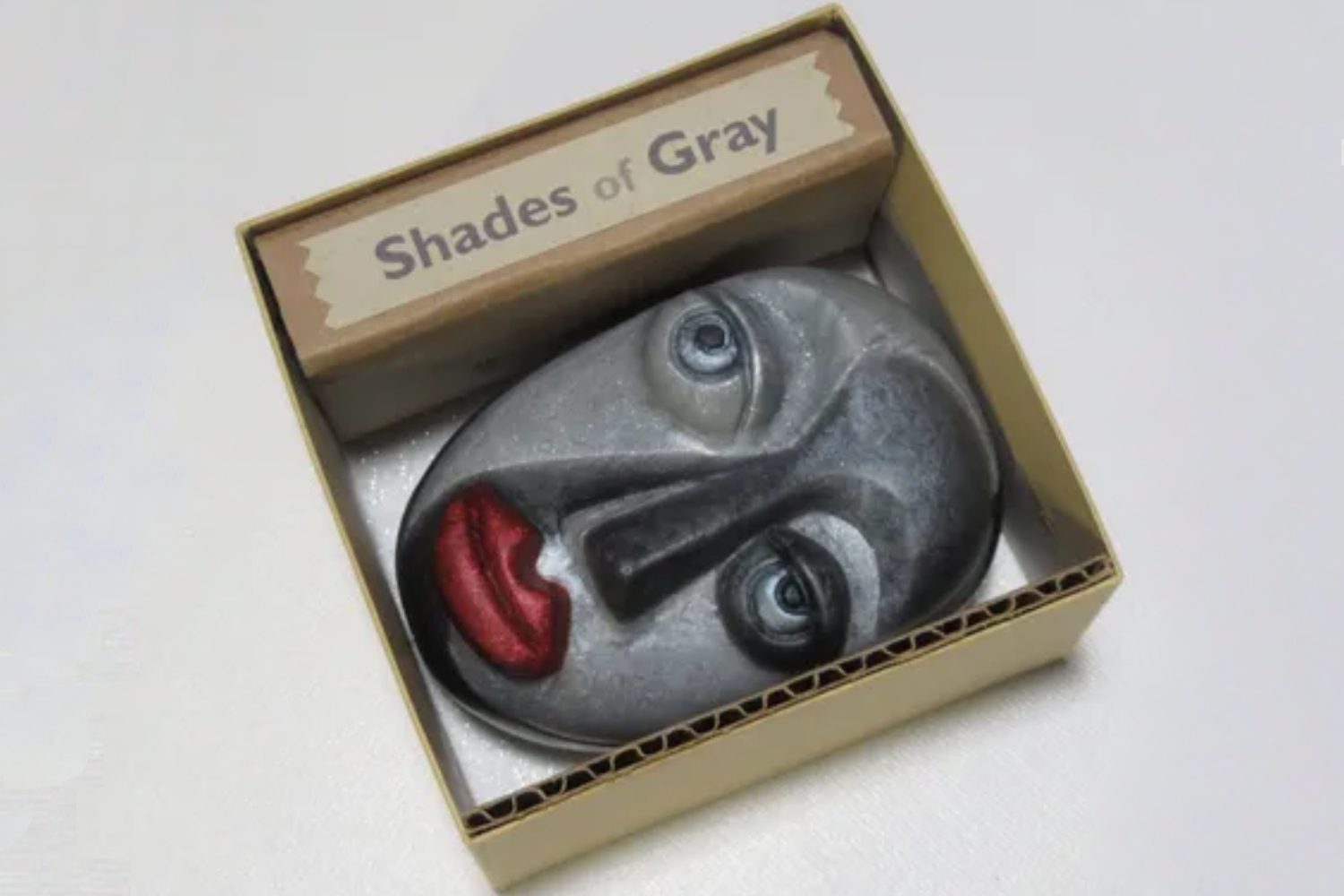 A box with a face in it and the words shades of gray