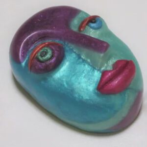A blue face with purple lips and eyes.