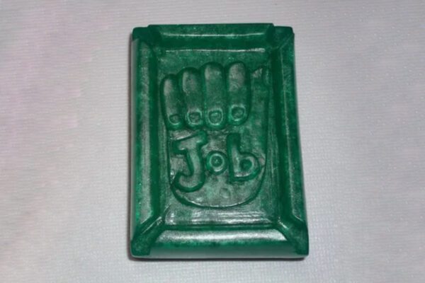 A green plastic object with the word " job " in it.