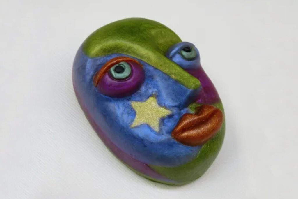 A colorful face with stars painted on it.