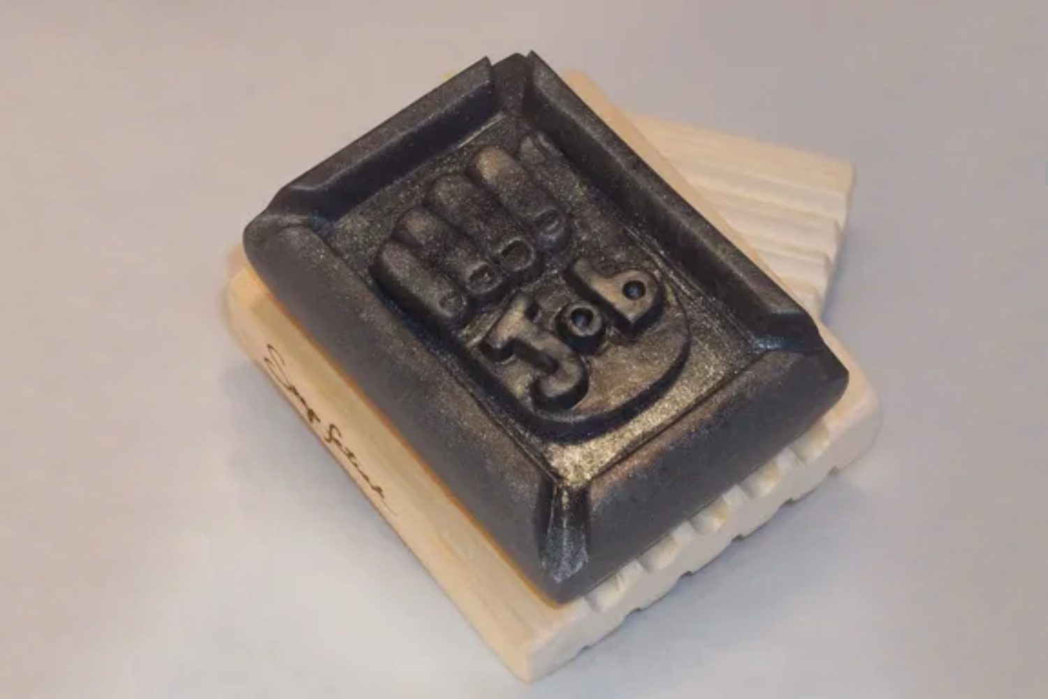 A soap stamp with the number 3 5 on it.