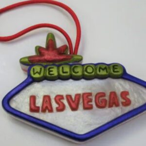 A las vegas sign ornament hanging on a string.
