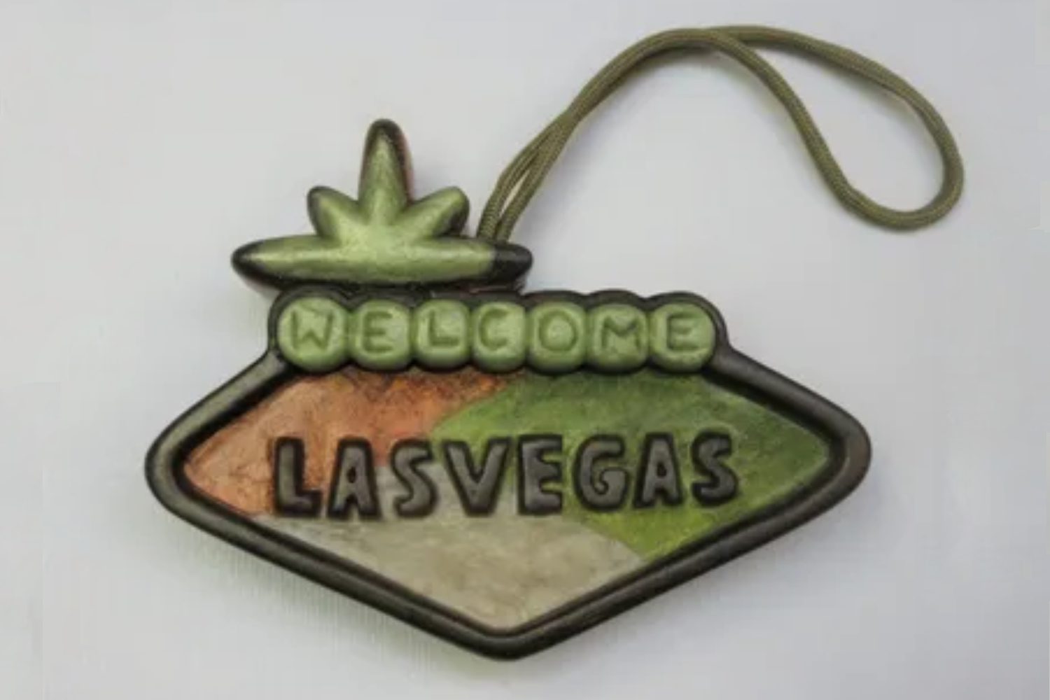 A green and brown sign that says " welcome las vegas ".
