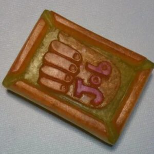 A rectangular piece of clay with the word " namaste " written on it.