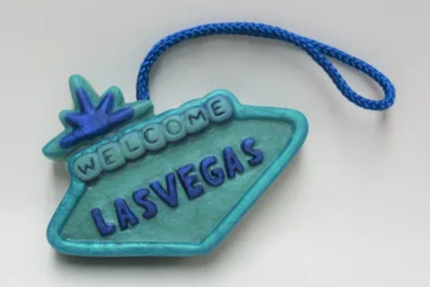 A blue sign with the words " welcome las vegas ".