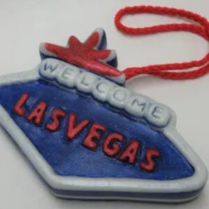 A blue and white las vegas sign with red lettering.