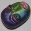 A purple and green face with pink lips.