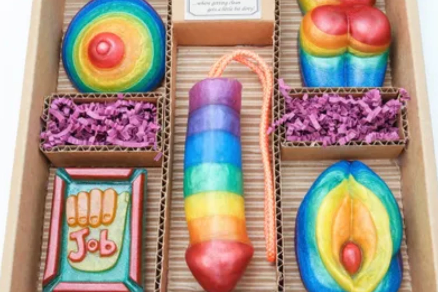 A box of colorful cookies with a rainbow design.