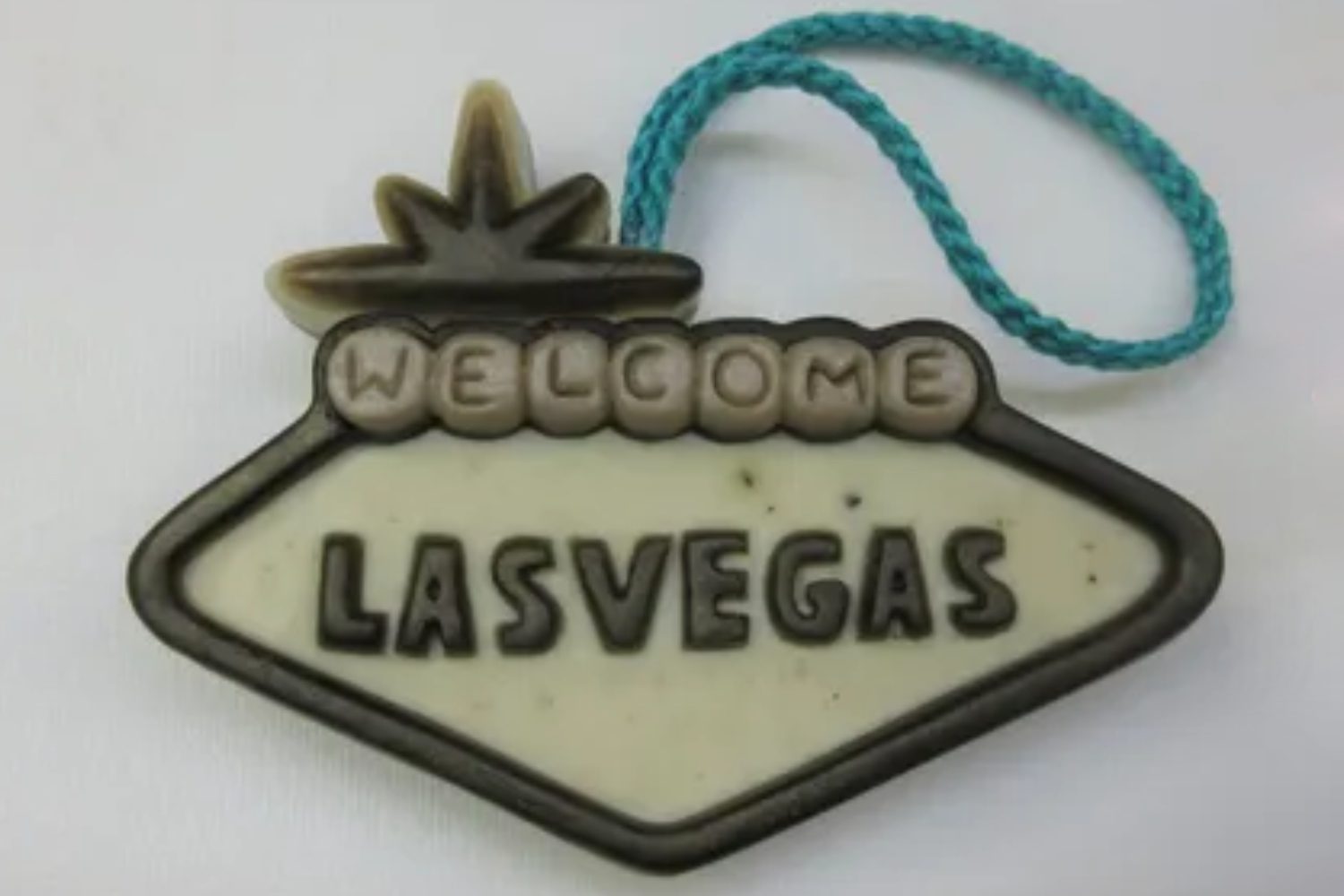 A las vegas sign ornament with the word welcome on it.