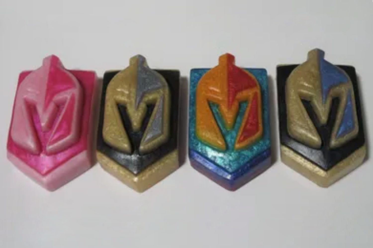 A group of four toy blocks with the letter v on them.
