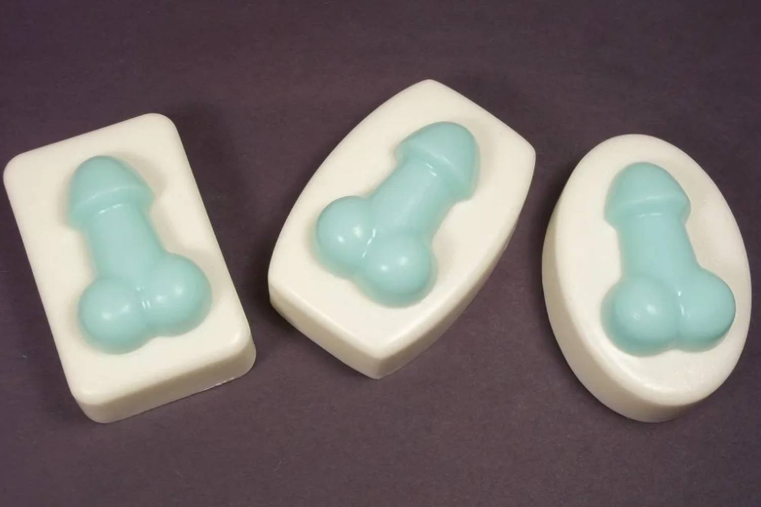 Three soap bars with a blue bone on them.