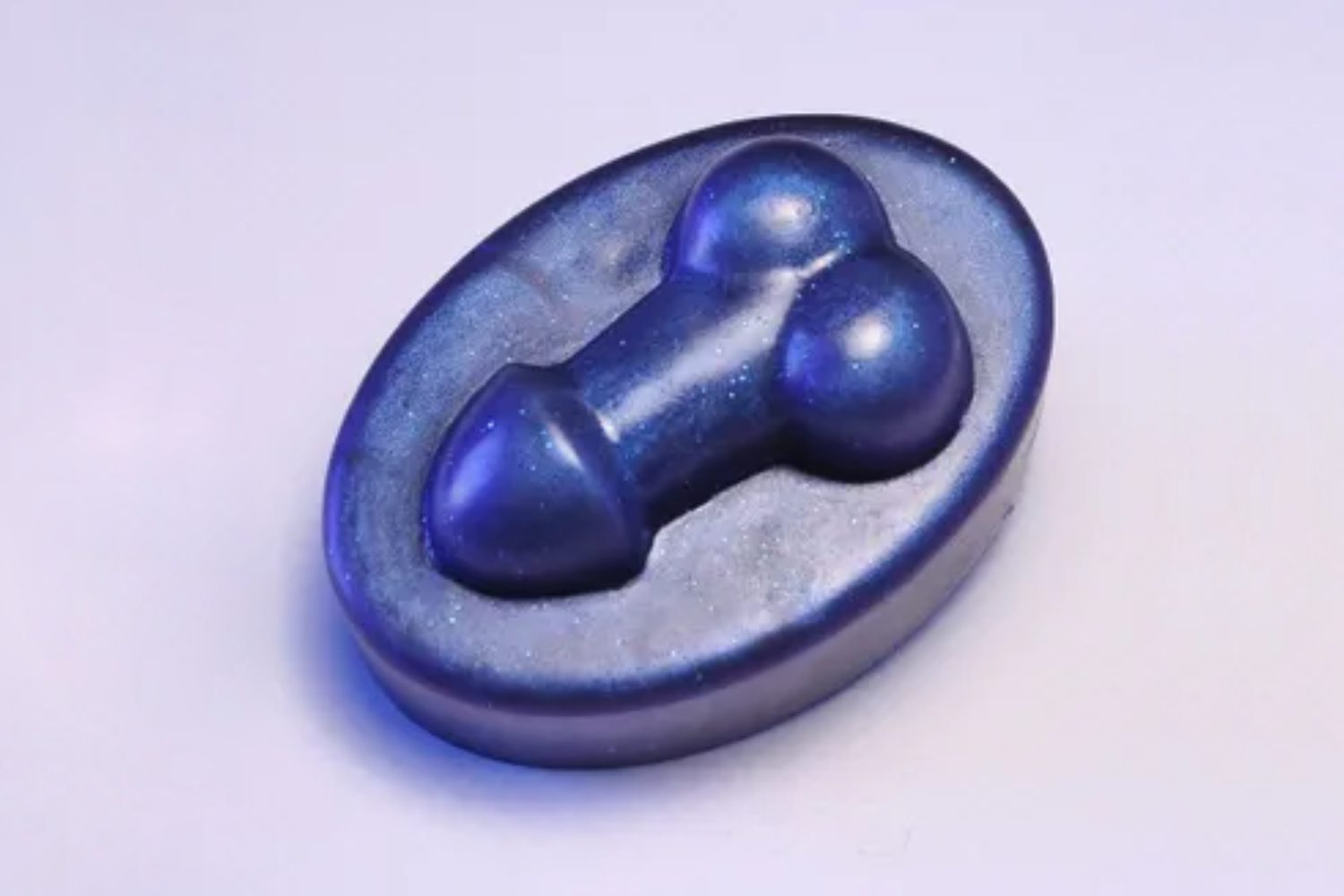 A blue soap with two balls in it