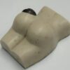 A white piece of soap shaped like a woman 's buttocks.