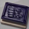A purple rectangular object with a picture of a hand.