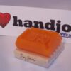 A soap on top of a wooden block.