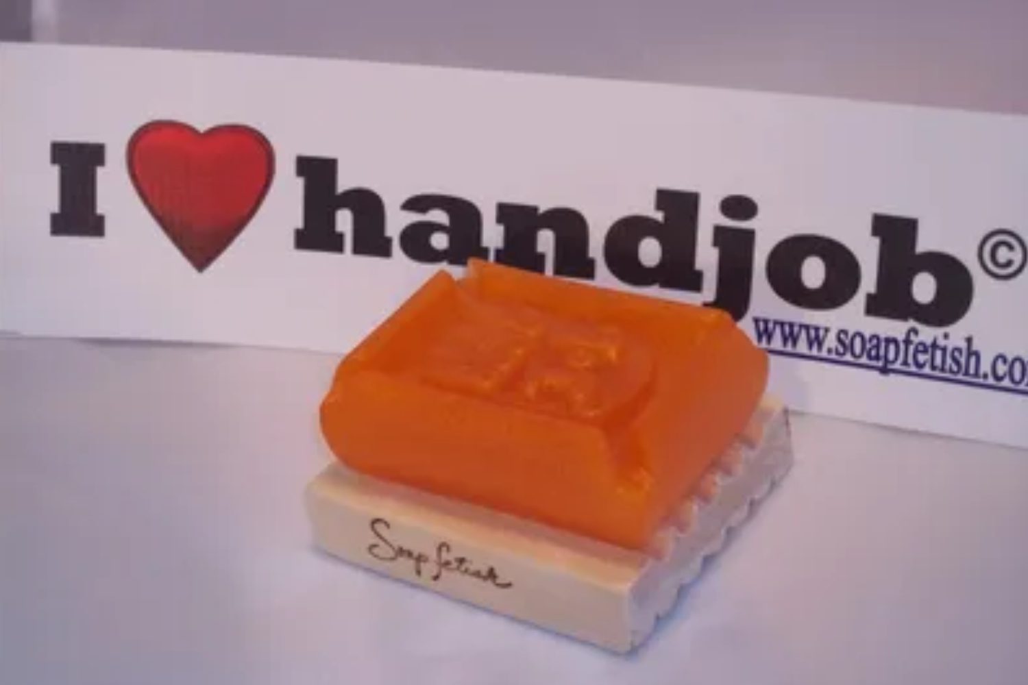 A soap on top of a wooden block.