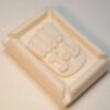 A white soap bar with the word " yes " in it.