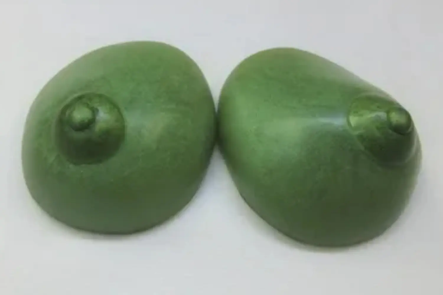 Two green apples sitting on top of a table.