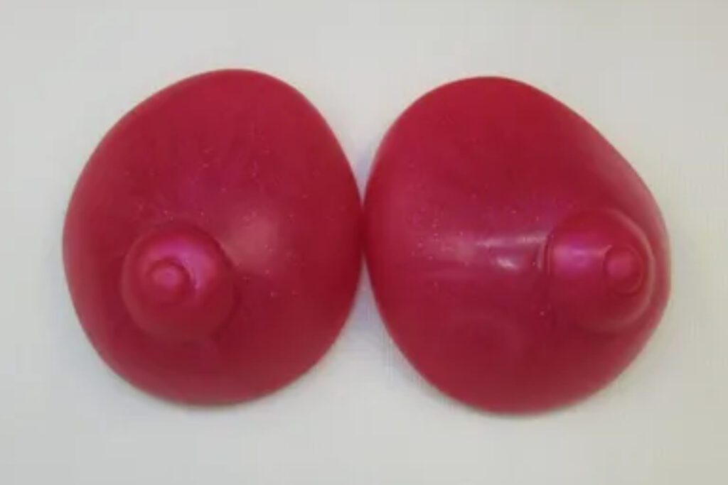 A pair of red buttons on top of a table.