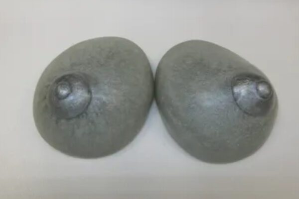 A pair of grey stone buttons on a white surface.