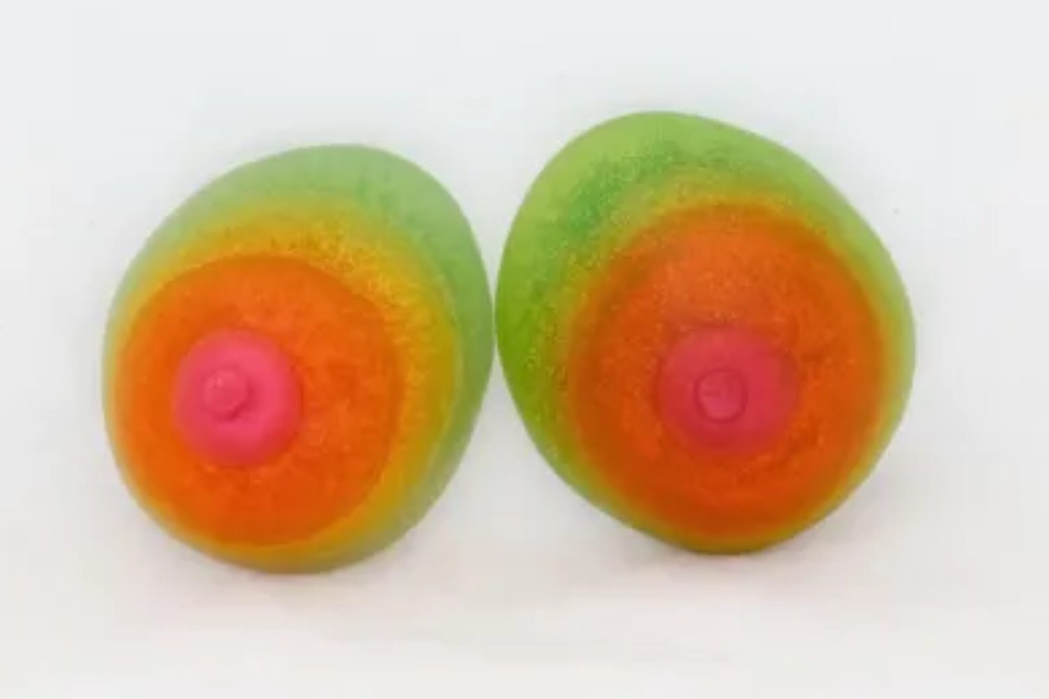 Two green and orange eggs with a pink top.