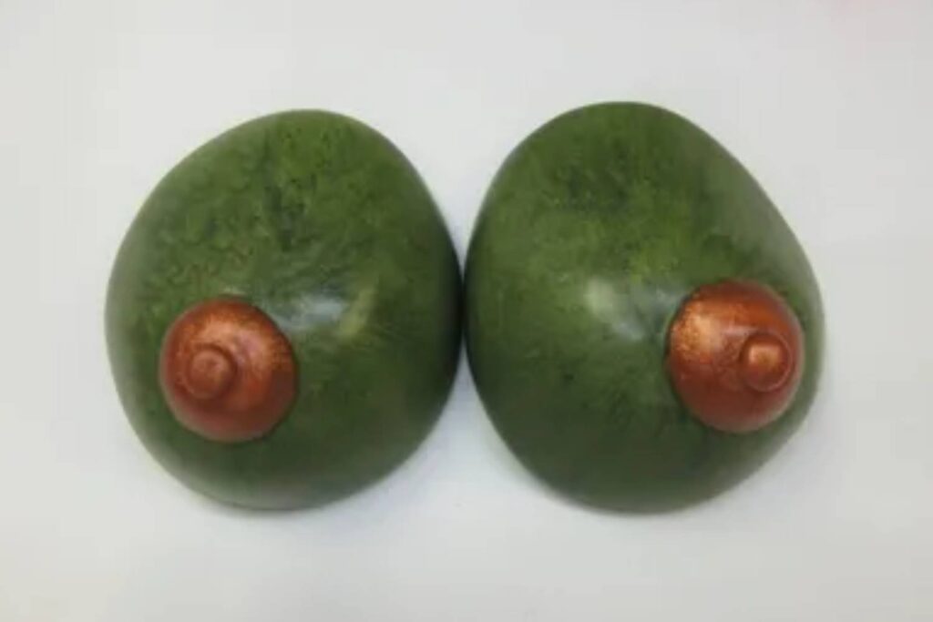 Two avocados with a spiral on them.