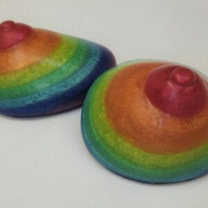 Two rainbow colored bowls sitting on top of a table.