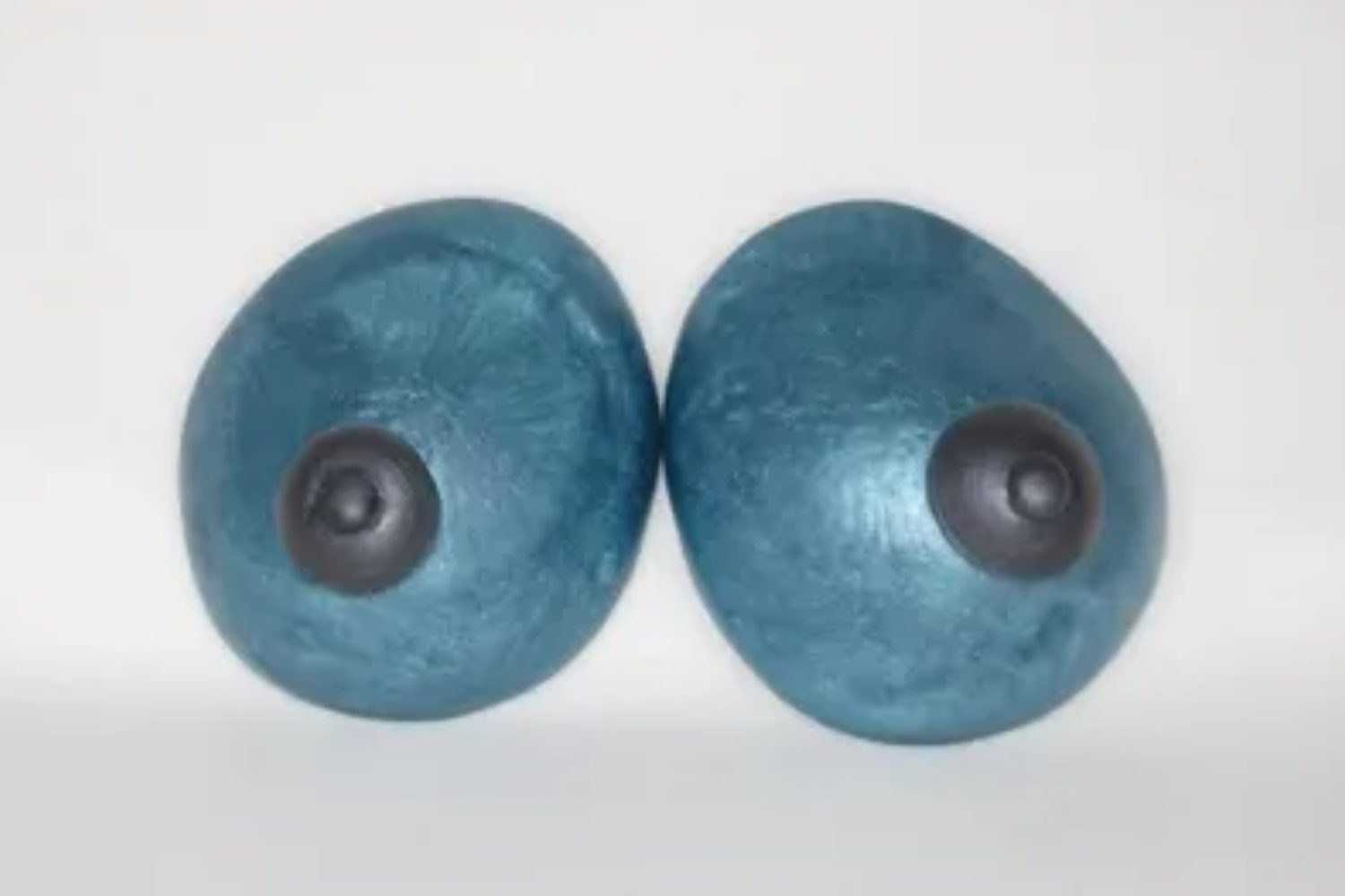 A pair of blue breasts with black eyes.