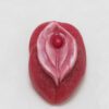 A red piece of candy with a pink leaf on top.