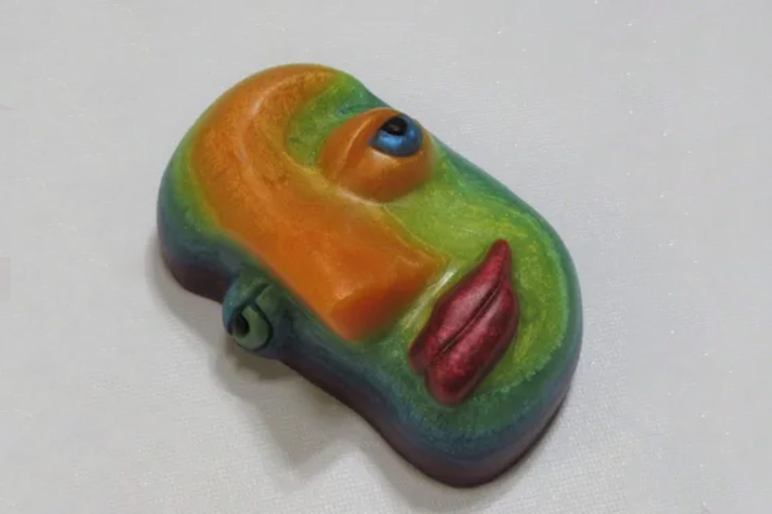 A colorful face shaped candy on top of a table.
