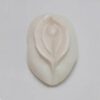 A white leaf shaped object sitting on top of a table.