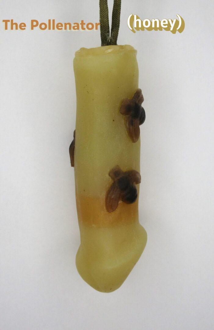 Beeswax candle with bee decorations.