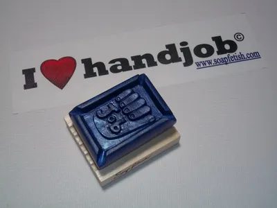 A rubber stamp with the hands of someone who is holding something.
