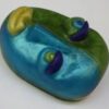 A blue and green object is sitting on top of the table.