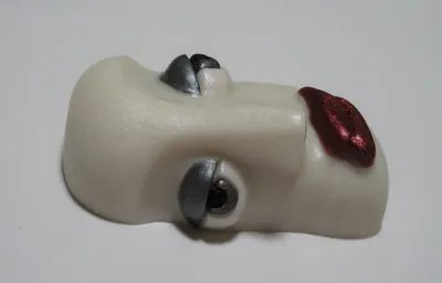 A white face with red lips and silver teeth.