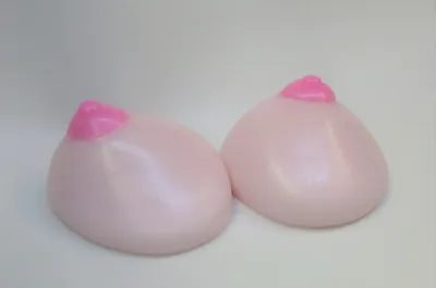 Two pink breasts with a pink lip on them.