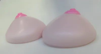 Two pink breast implants sitting on top of a table.