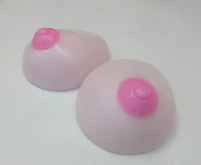 Two pink breast implants are sitting on a table.