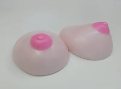 Two pink soap shapes sitting on top of a table.