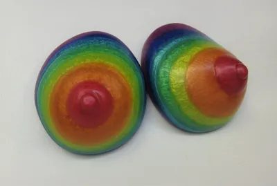 A pair of rainbow colored eggs sitting on top of a table.