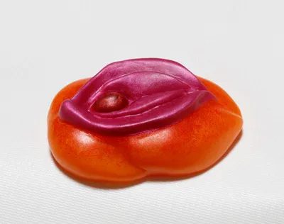 A close up of an orange and red jelly bean