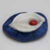 A blue and white dish with red on top